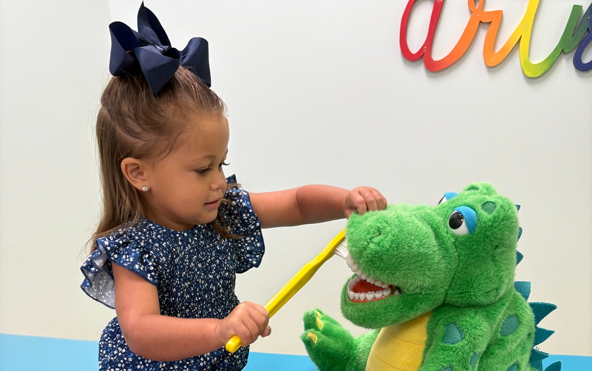 Girl Practices Brushing for Oral Hygiene Habit Development
